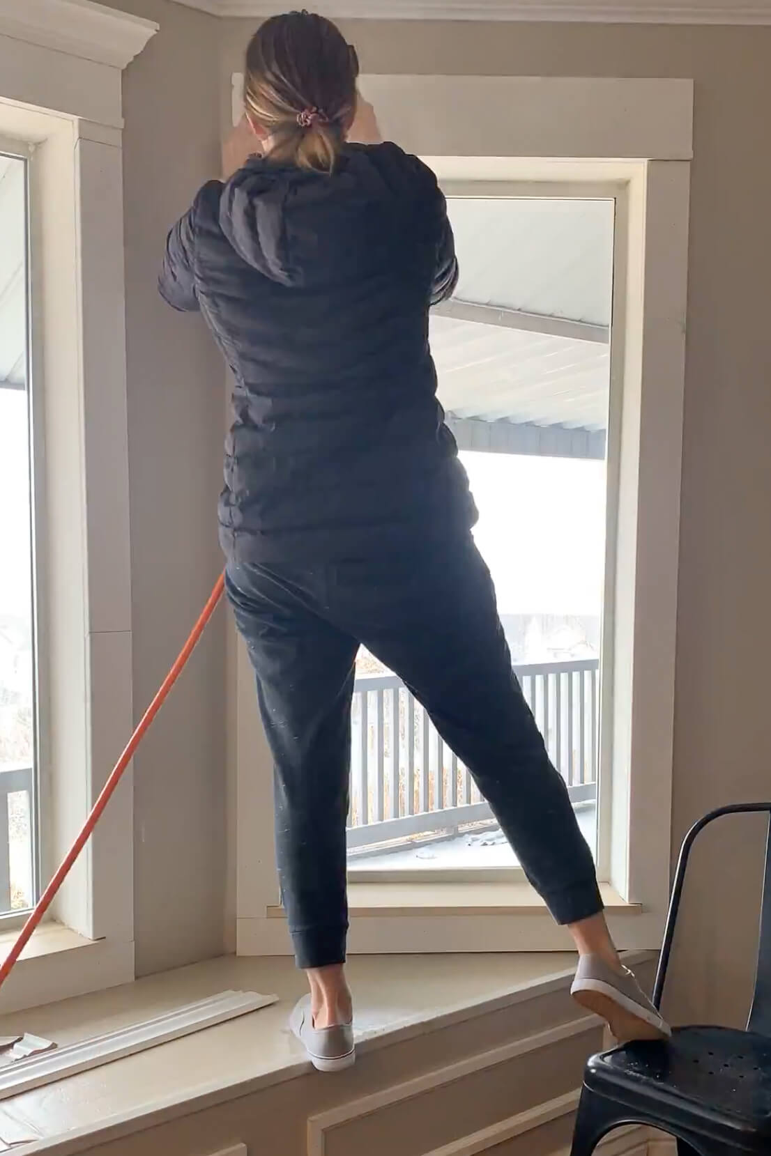 Adding window trim to a bay window.